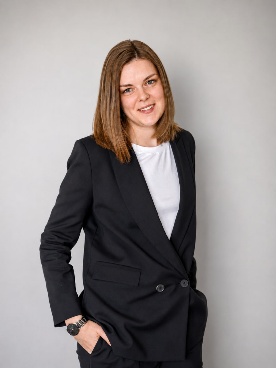 Daryna Bukrieieva standing against a light wall