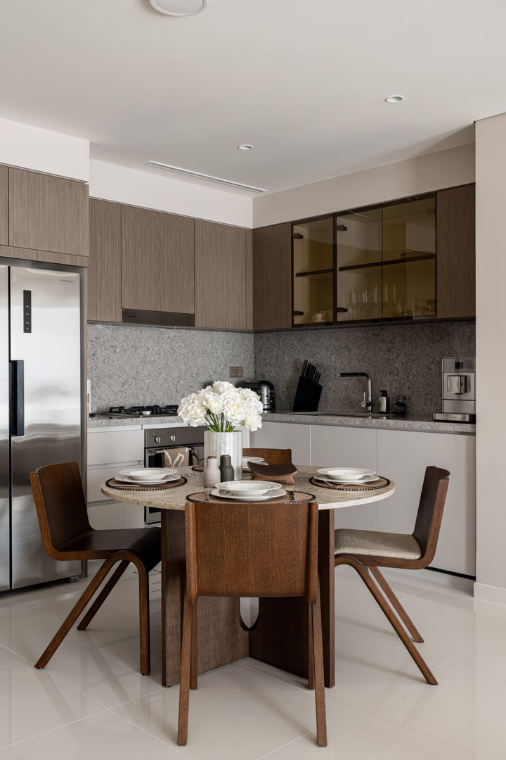Dining table and timber kitchen in the Dubai apartment
