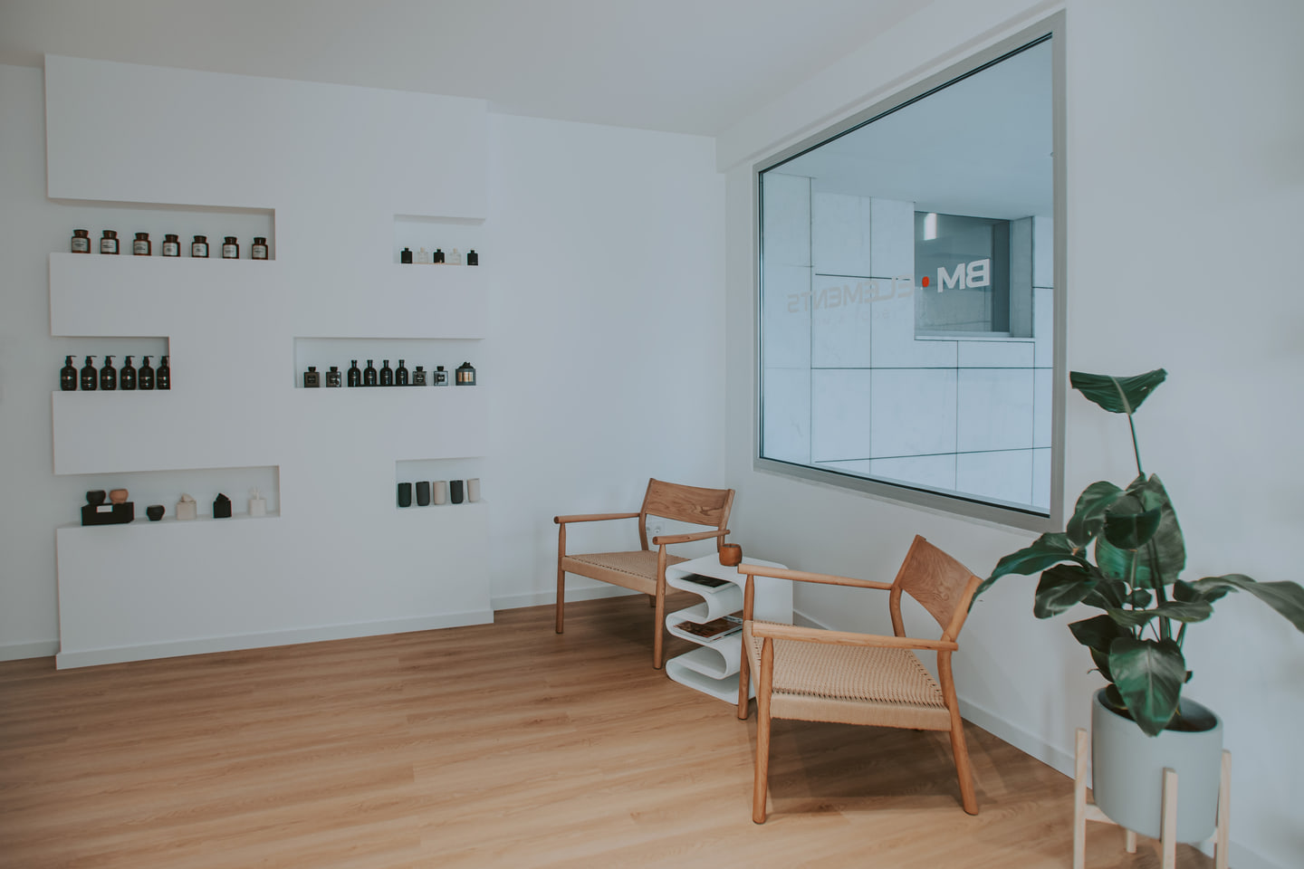 Waiting area with timber chairs and inset product shelves