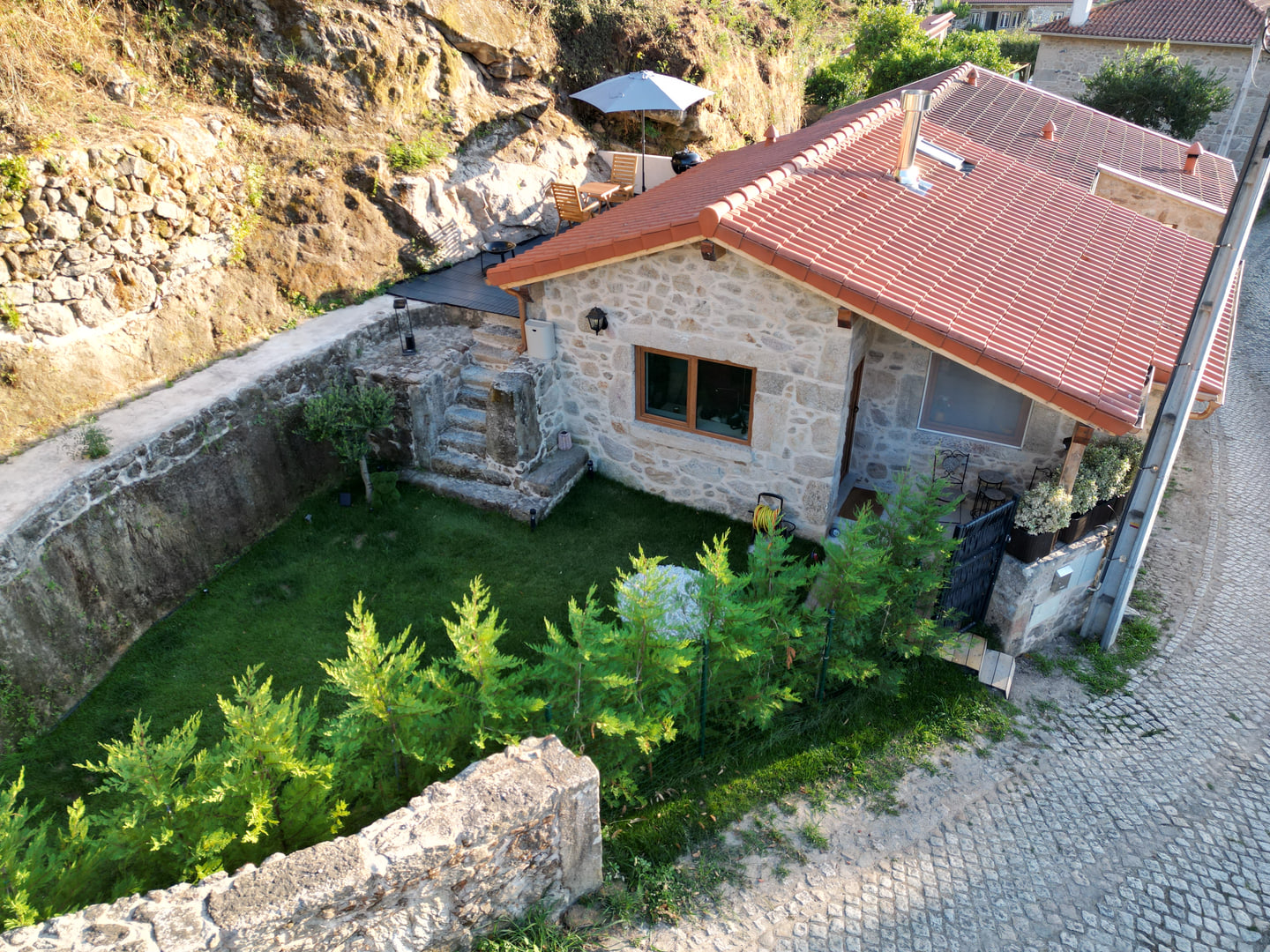 Aerial view of the historical stone house and garden in Cerdal