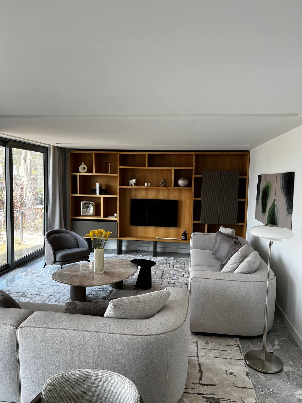 Bodrum villa living room with curved seating and a dark timber wall